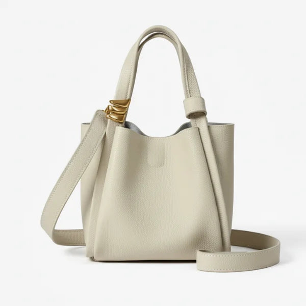 Arden Genuine Leather Bucket Bag in off-white, front studio view highlighting compact bucket silhouette with top handles and crossbody strap