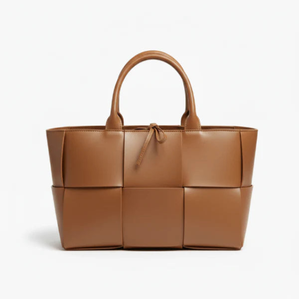 Front view of Aurelia caramel genuine leather tote bag with woven texture, leather handles, and tie closure