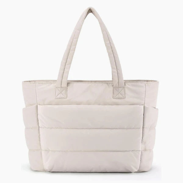 Front view of off-white puffer-style tote bag with soft quilted texture and durable handles for versatile use
