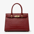 Front view of Adara genuine leather wine red satchel bag featuring crocodile texture and gold clasp accents