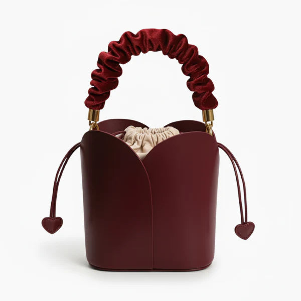Althea Vegan Leather Bucket Bag in wine red, front studio view showcasing tulip-inspired silhouette with ruched handle and heart pulls