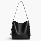 Amara Vegan Leather Bucket Bag in black, front studio view highlighting clean bucket silhouette and long shoulder strap