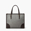 Front view of the Anelisse vegan leather tote bag in grey, with sleek design and elegant brown leather corners