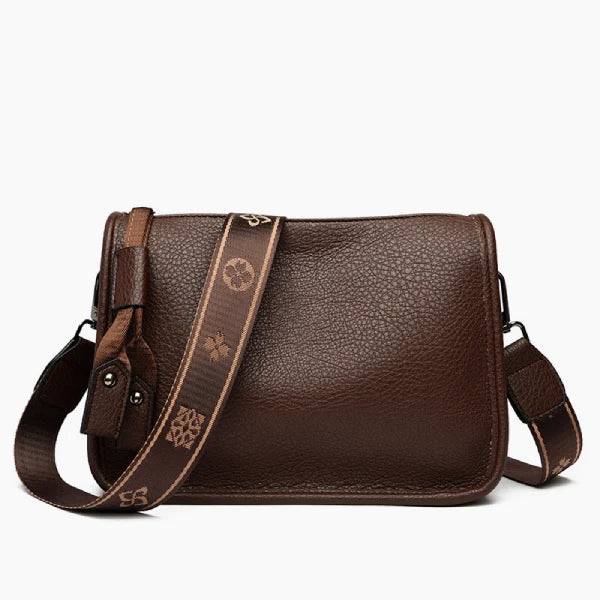 Auralis Genuine Cowhide Crossbody Bag in brown, front studio view showcasing zip-top design, adjustable shoulder strap, and everyday size