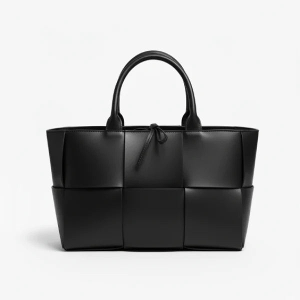 Front view of Aurelia black genuine leather tote bag with woven texture and leather handles, featuring a minimalistic design