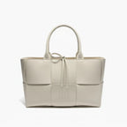 Front view of Aurelia off-white genuine leather tote bag with woven texture, leather handles, and tie closure
