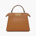 Front view of brown woven vegan leather satchel bag with gold clasp, handle, and structured design