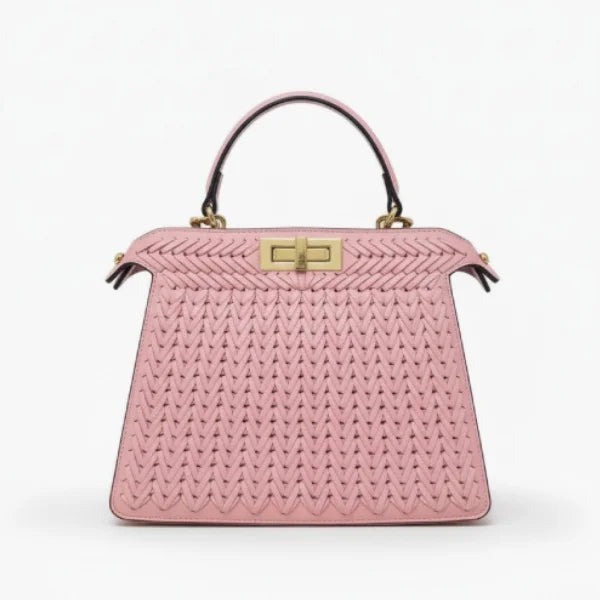 Front view of pink woven vegan leather satchel bag with gold clasp, handle, and structured design