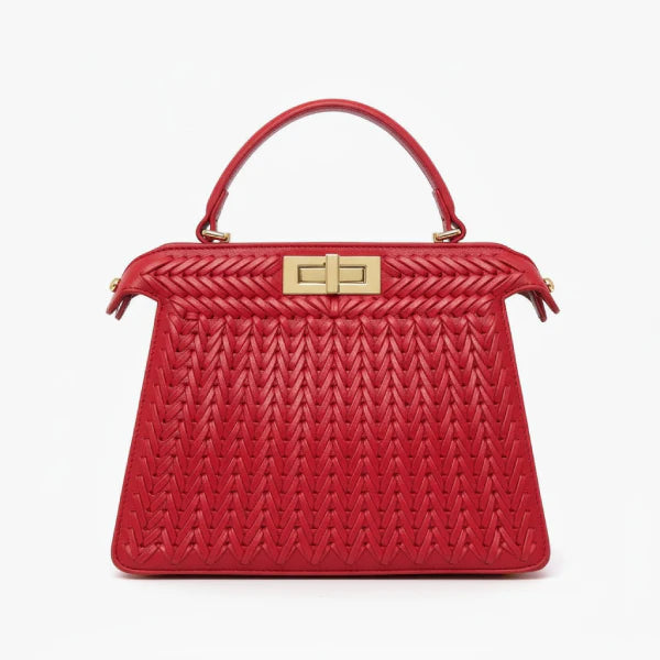 Front view of red woven vegan leather satchel bag with gold clasp, handle, and structured design