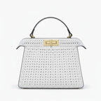 Front view of white woven vegan leather satchel bag with gold clasp, handle, and structured design