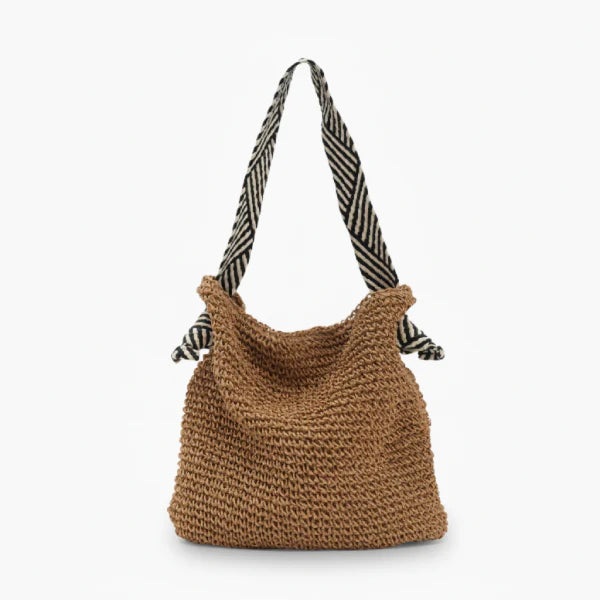 Front view of brown woven tote bag with striped black and white handles, designed for casual and beach outings