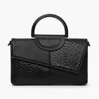 Front view of a black vegan leather satchel bag with a unique croc-embossed and smooth leather design, showcasing its structured shape and top handle
