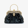 Front view of a black vegan leather evening bag with a rhinestone-studded gold frame and pleated design