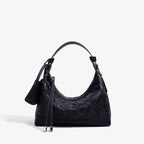 Front view of Ismara genuine leather woven hobo bag in black, with a modern design and woven leather detail