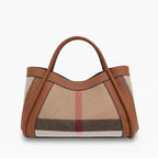 Front view of a brown canvas and leather tote bag with dual leather handles and a sleek design