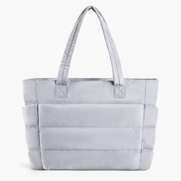 Front view of grey puffer-style tote bag with quilted texture and comfortable handles, ideal for everyday use
