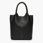 Front view of black cowhide leather tote bag with sleek, structured design and white stitching detail for a modern look