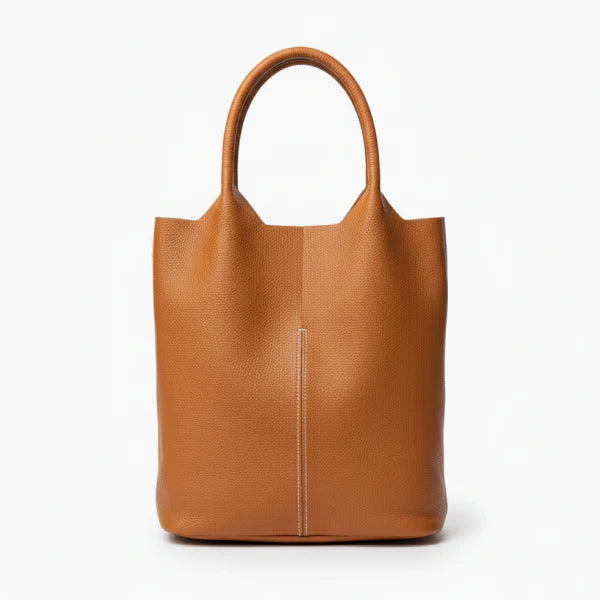 Front view of caramel cowhide leather tote bag with smooth leather finish and central seam, offering a sophisticated and minimalist design