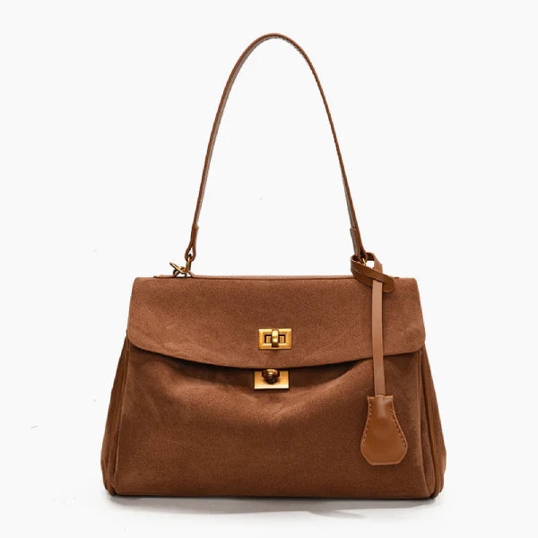 Front view of brown velvet satchel bag featuring two gold clasps and a structured design