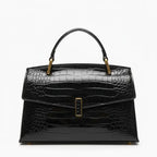 Front view of black crocodile leather satchel bag featuring a gold clasp and smooth glossy texture