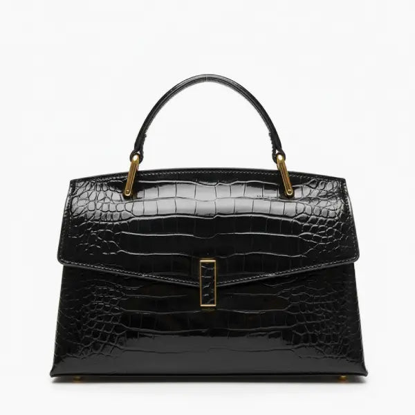 Front view of black crocodile leather satchel bag featuring a gold clasp and smooth glossy texture