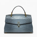 Front view of blue crocodile leather satchel bag featuring a gold clasp and glossy textured finish