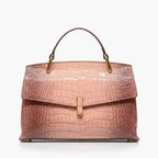  Front view of pink crocodile leather satchel bag featuring a gold clasp and glossy textured finish