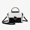 Front view of the black and white vegan leather satchel bag with a unique geometric design, featuring a gold-tone metal clasp