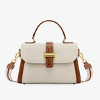 Front view of the off-white genuine leather satchel bag with brown leather accents and a gold-tone clasp, offering a stylish and sophisticated design