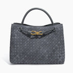 Front view of the Veyra vegan leather tote bag in gray, showcasing its sophisticated woven texture and luxurious gold-tone knot accent