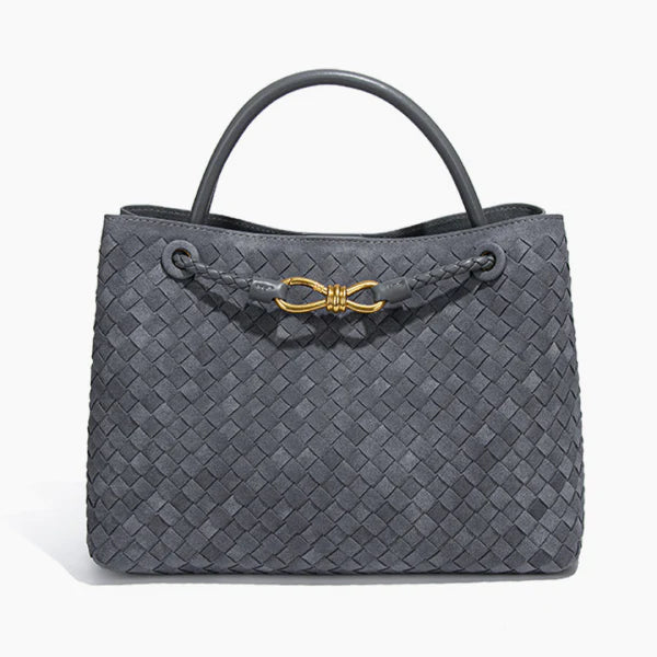 Front view of the Veyra vegan leather tote bag in gray, showcasing its sophisticated woven texture and luxurious gold-tone knot accent
