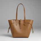Front view of the Zairen genuine cowhide tote bag in brown with sleek design and adjustable side straps