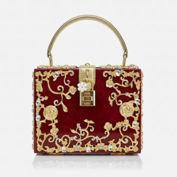 Front view of Zephyra acrylic evening bag in red with gold floral design and lock closure